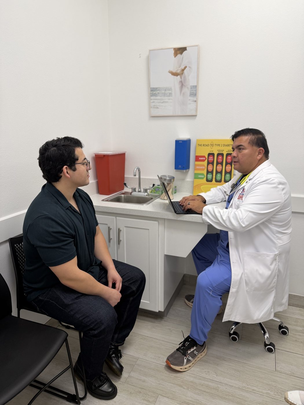 Daniel Mego consulting with an adult patient
