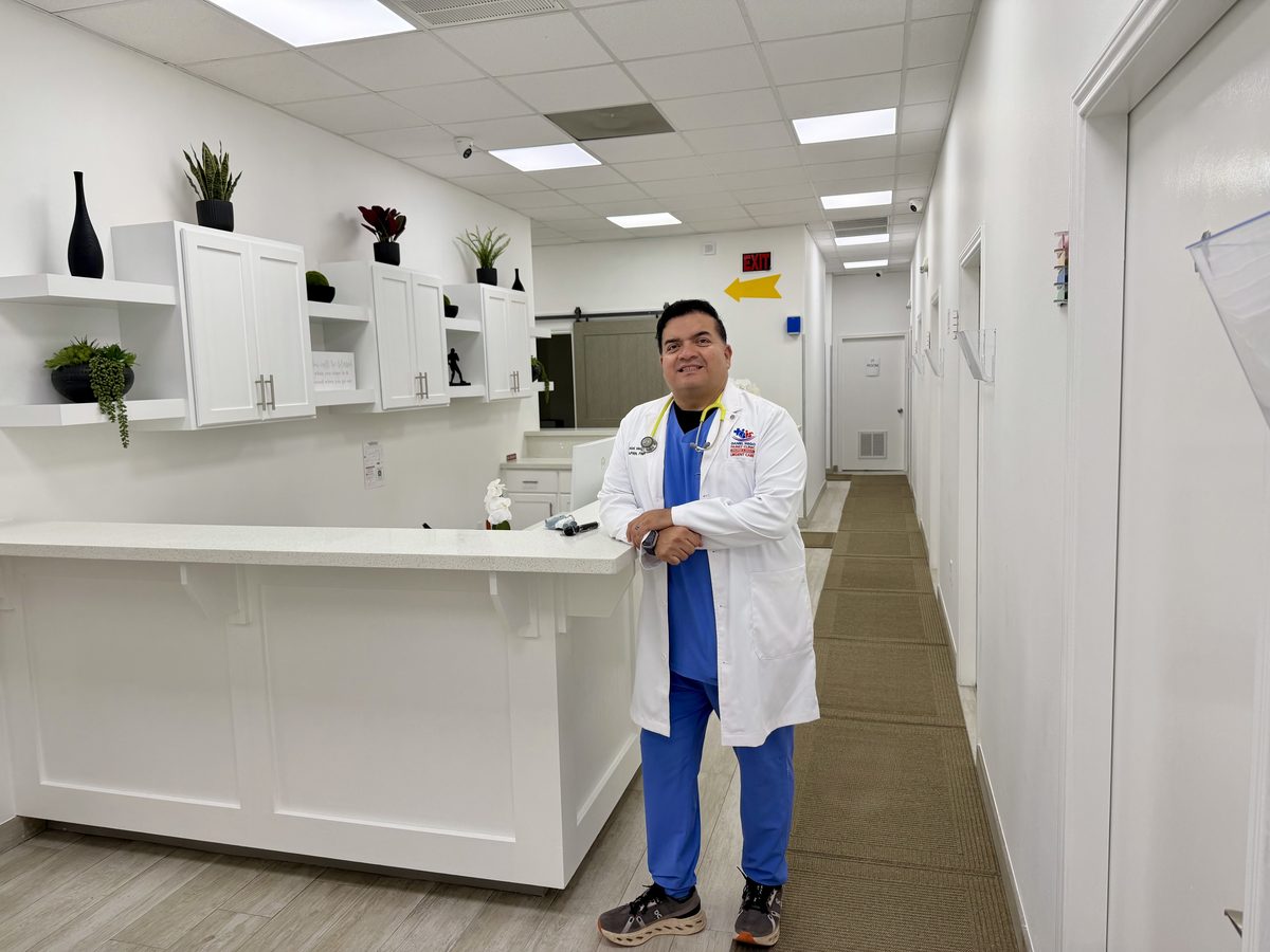 Daniel Mego, FNP-C, in his white coat with stethoscope